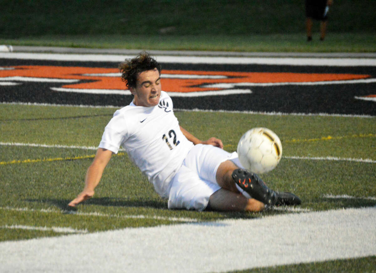 Edwardsville senior center back Matt Busse keeps a ball from going out of bounds midway through the first half in Tuesday’s game against Collinsville at the District 7 Sports Complex. 