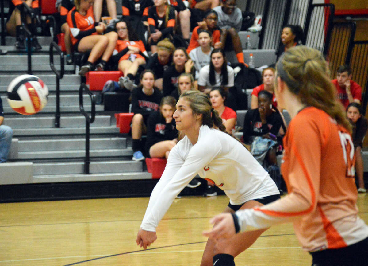 Edwardsville’s Megan Woll successfully receives a serve during the second game.