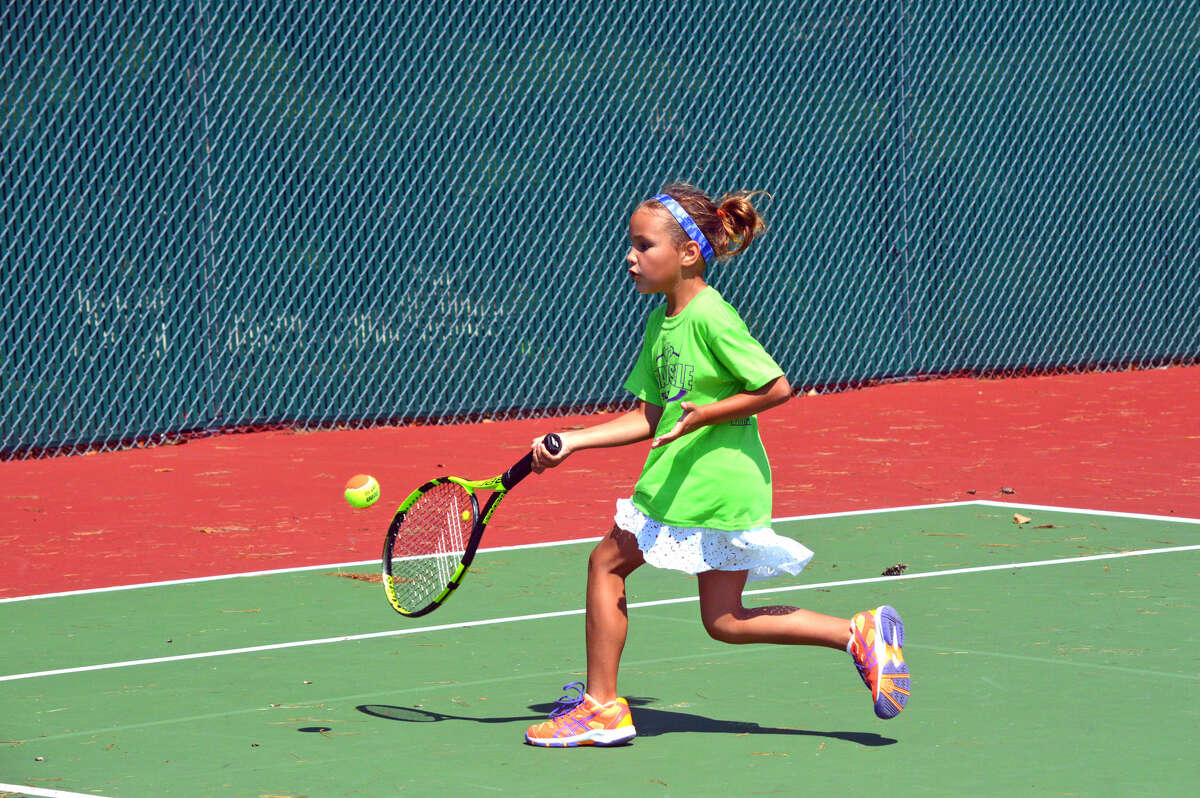 Katie Woods of Edwardsville makes a return during her match in the coed singles 10-and-under A Division.