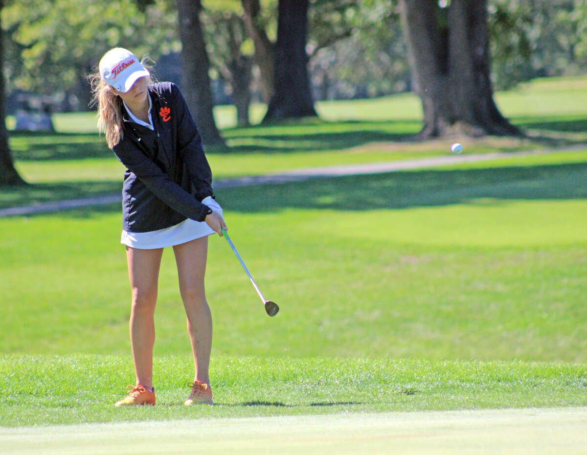 Edwardsville junior Addy Zeller chips a shot on to the green on hole No. 17 at Belk Park Golf Course during the Southwestern Conference Tournament on Monday in Wood River. 