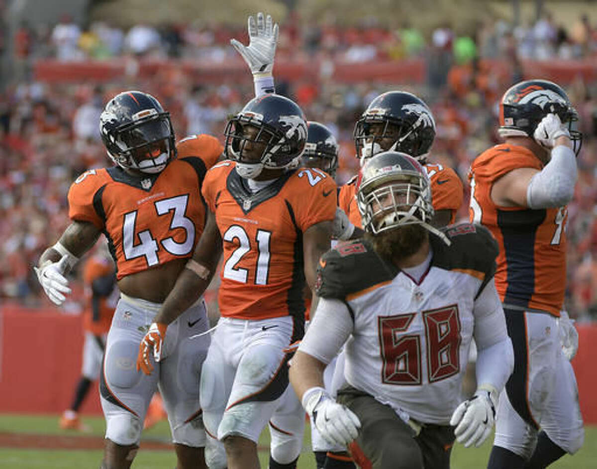FILE - In this Oct. 2, 2016, file photo, Denver Broncos cornerback Aqib Talib (21) celebrates with strong safety T.J. Ward (43) after Talib intercepted a pass by Jameis Winston during the second quarter of an NFL football game, in Tampa, Fla. For the first time since 2006, the Raiders (6-2) have an opportunity to play on the NFL's premier Sunday night stage when they host the Broncos (6-2) on Sunday night in an AFC West showdown. "We've never liked the Raiders," safety T.J. Ward said. (AP Photo/Phelan Ebenhack, File)