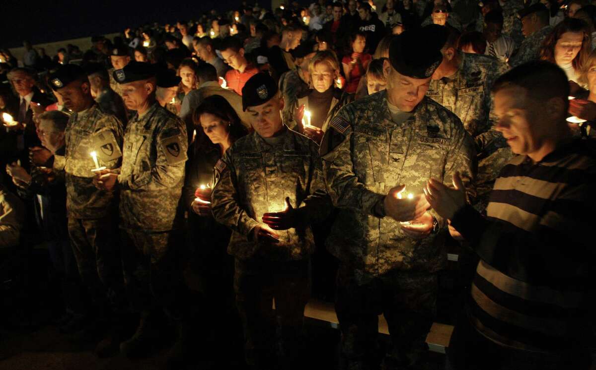 Soldiers hold a candle light vigil at Fort Hood, Texas, Friday, Nov. 6, 2009. Authorities said Maj. Nidal Malik Hasan shot and killed 13 people at Fort Hood, Texas on Thursday. (AP Photo/LM Otero)