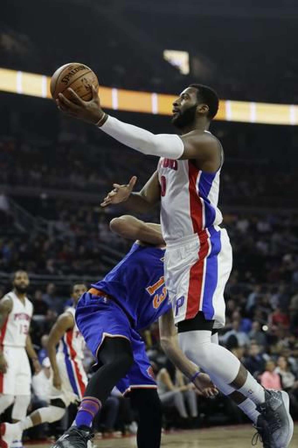 Detroit Pistons center Andre Drummond (0) makes a layup as New York Knicks center Joakim Noah defends during the first half of an NBA basketball game, Tuesday, Nov. 1, 2016, in Auburn Hills, Mich. (AP Photo/Carlos Osorio)