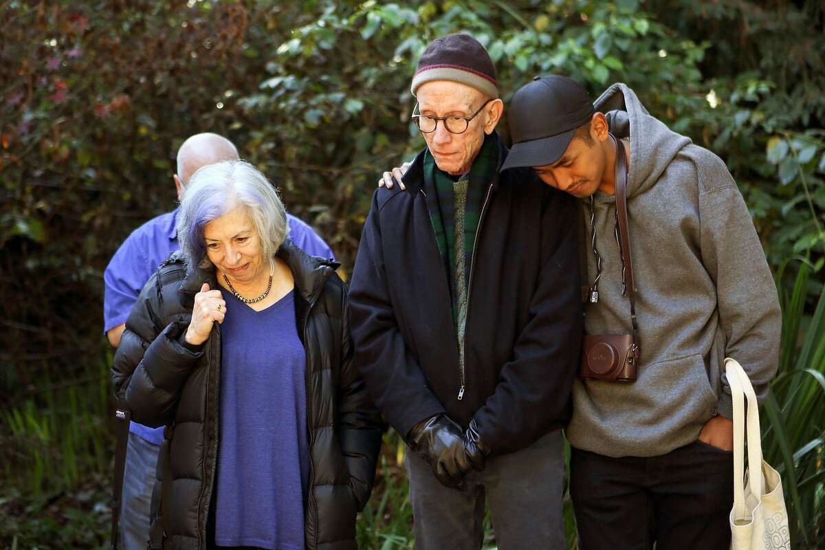 Alison Moed Paolercio, John Chard (center) and Christopher Baguiolook at Chard's partner's name, Steve Keith, at the World AIDS Day celebration at Circle of Friends Aids Memorial Grove in Golden Gate Park on Thursday, December 1, 2016 in San Francisco, Calif.