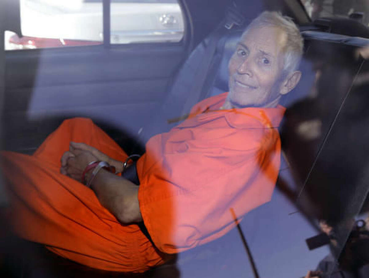 FILE - In March 17, 2015, file photo, New York real estate heir Robert Durst smiles as he is transported from Orleans Parish Criminal District Court to the Orleans Parish Prison after his arraignment on murder charges in New Orleans. Durst has made his long-awaited arrival in California to face charges of killing a friend 16 years ago. The Los Angeles County District Attorney's Office says Durst was locked up in a county jail Friday, Nov. 4, 2016. He's scheduled to face arraignment Monday for the killing of friend Susan Berman in 2000. (AP Photo/Gerald Herbert, File)