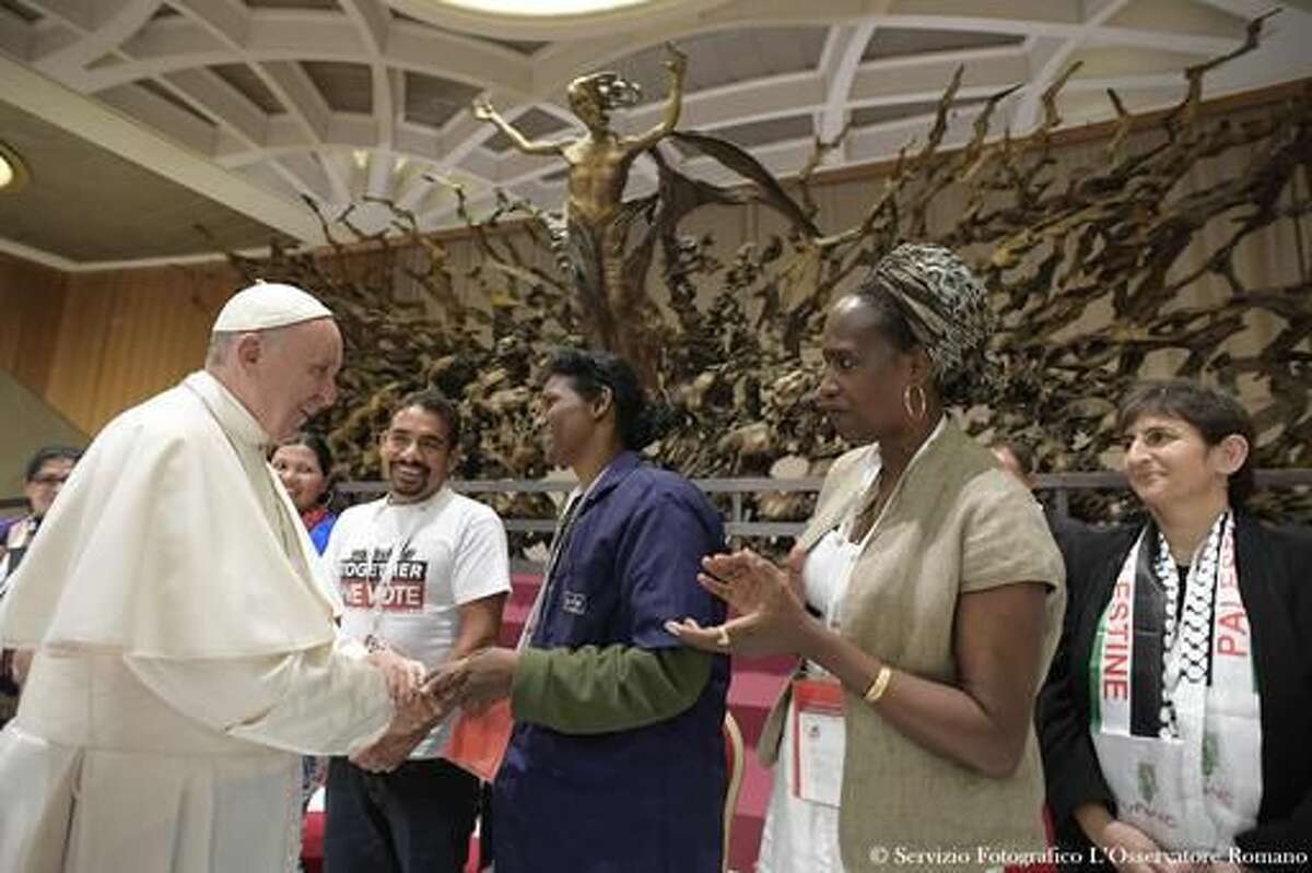 Pope Francis salutes at the end of an audience with representatives of the popular movements at the Vatican Saturday, Nov. 5, 2016. (L'Osservatore Romano/Pool Photo via AP)