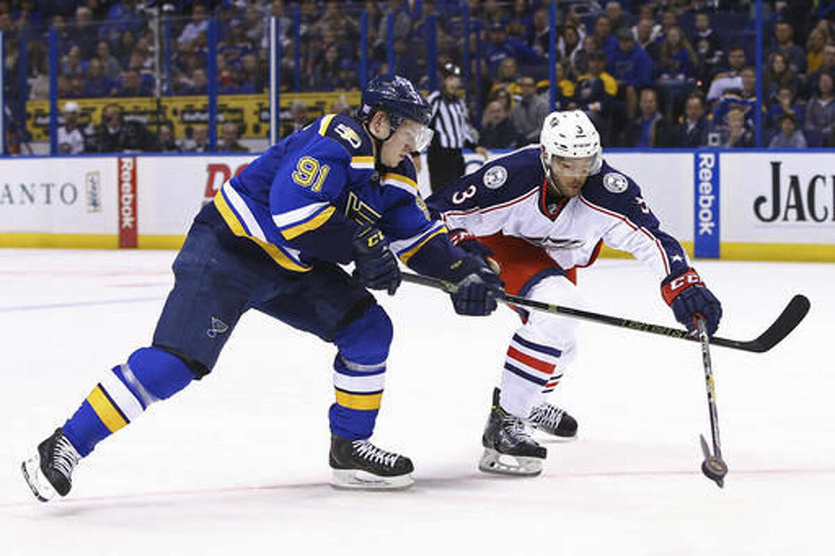 St. Louis Blues' Vladimir Tarasenko, left, of Russia, and Columbus Blue Jackets' Seth Jones reach for the puck during the second period of an NHL hockey game Saturday, Nov. 5, 2016, in St. Louis. (AP Photo/Billy Hurst)