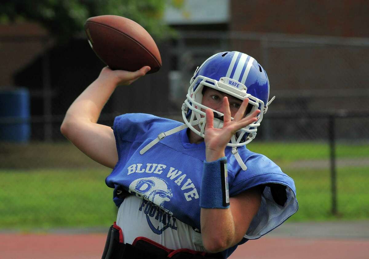 Darien quarterback Brian Peters takes warm up tosses at a varsity football practice at the high school in Darien on Sept. 1, 2016.