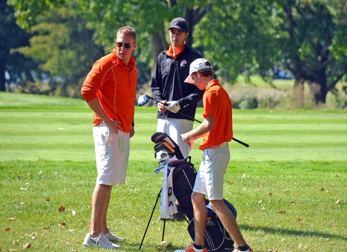 Edwardsville coach Adam Tyler, left, talks to senior Spencer Patterson, center, and junior Tanner White during Monday’s Class 3A Pekin Sectional at Lick Creek Golf Course.