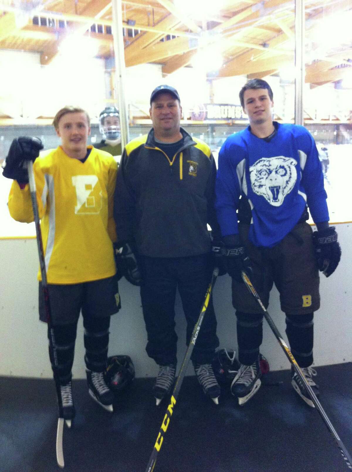 From left to right, co-captain Christian LeSueur, head coach Ron VanBelle and co-captain Nick VanBelle lead the Brunswick School hockey team into its new season.