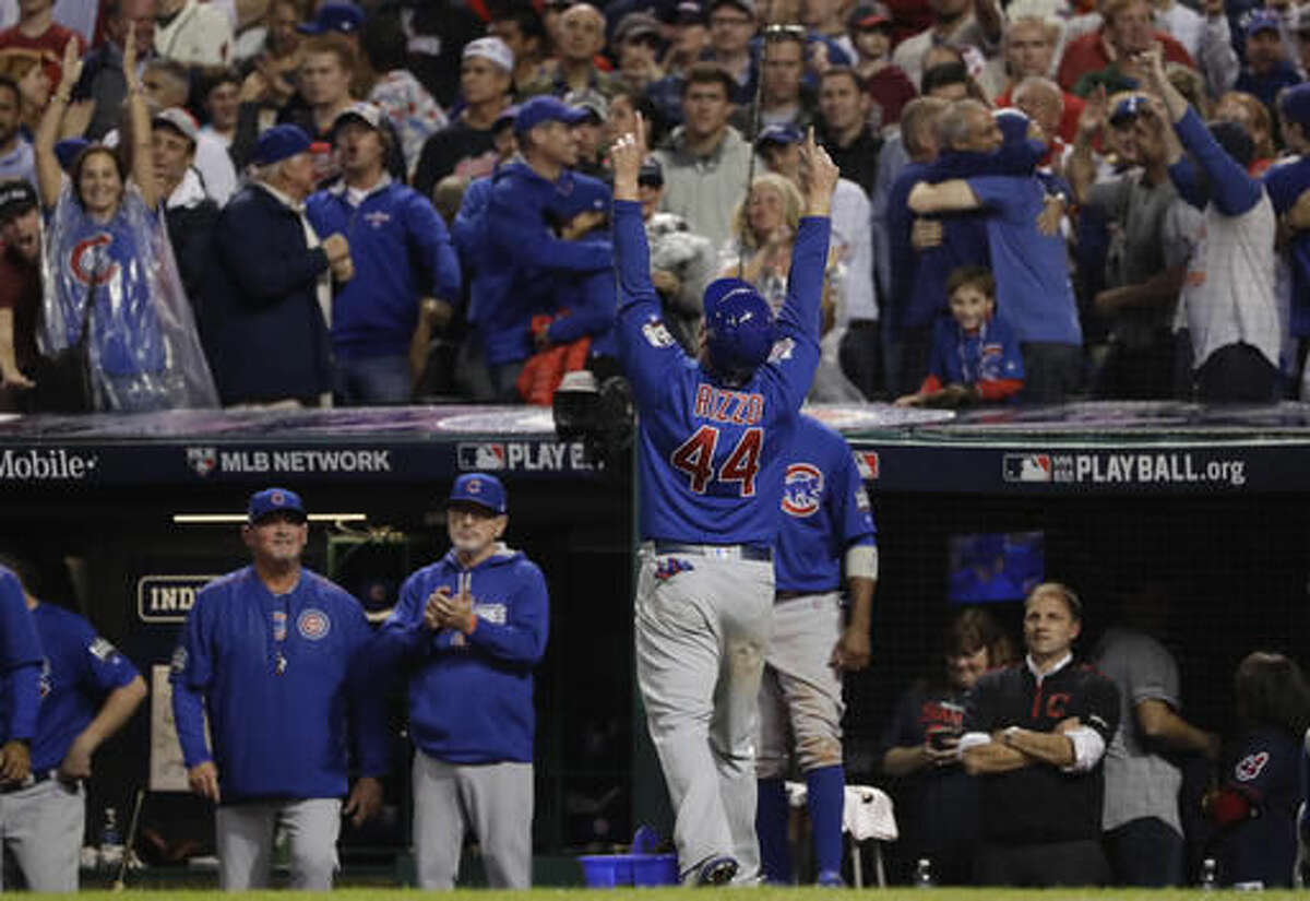 Chicago Cubs' Anthony Rizzo celebrates in the dugout after scoring on a hit by Miguel Montero during the 10th inning of Game 7 of the Major League Baseball World Series against the Cleveland Indians Thursday, Nov. 3, 2016, in Cleveland. (AP Photo/Matt Slocum)