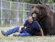 In this Wednesday, Sept. 7, 2016 photo, Jim Kowalczik plays with Jimbo, a 1500-pound Kodiak bear, at the Orphaned Wildlife Center in Otisville, N.Y. (AP Photo/Mike Groll)