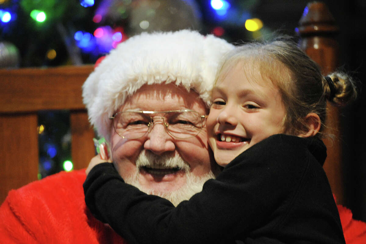 Chloe Patterson, age 7, hugs Santa at the Midland College Holiday Evening event on Thursday, Dec. 1, 2016. James Durbin/Reporter-Telegram