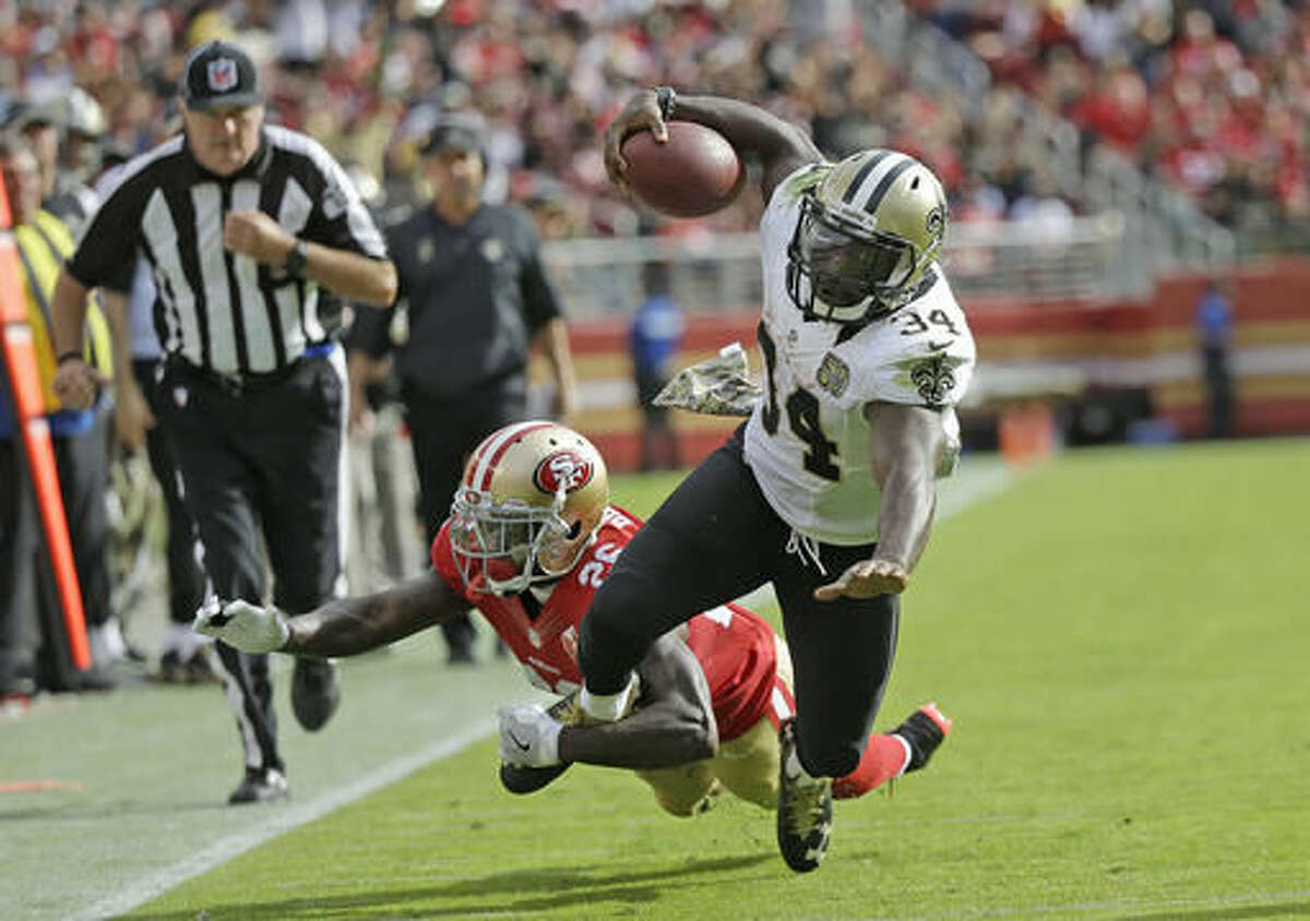 New Orleans Saints running back Tim Hightower goes tumbling with ball while being stopped by San Francisco 49ers cornerback Tramaine Brock, left, during the first half of an NFL football game Sunday, Nov. 6, 2016, in Santa Clara, Calif. (AP Photo/Tony Avelar)
