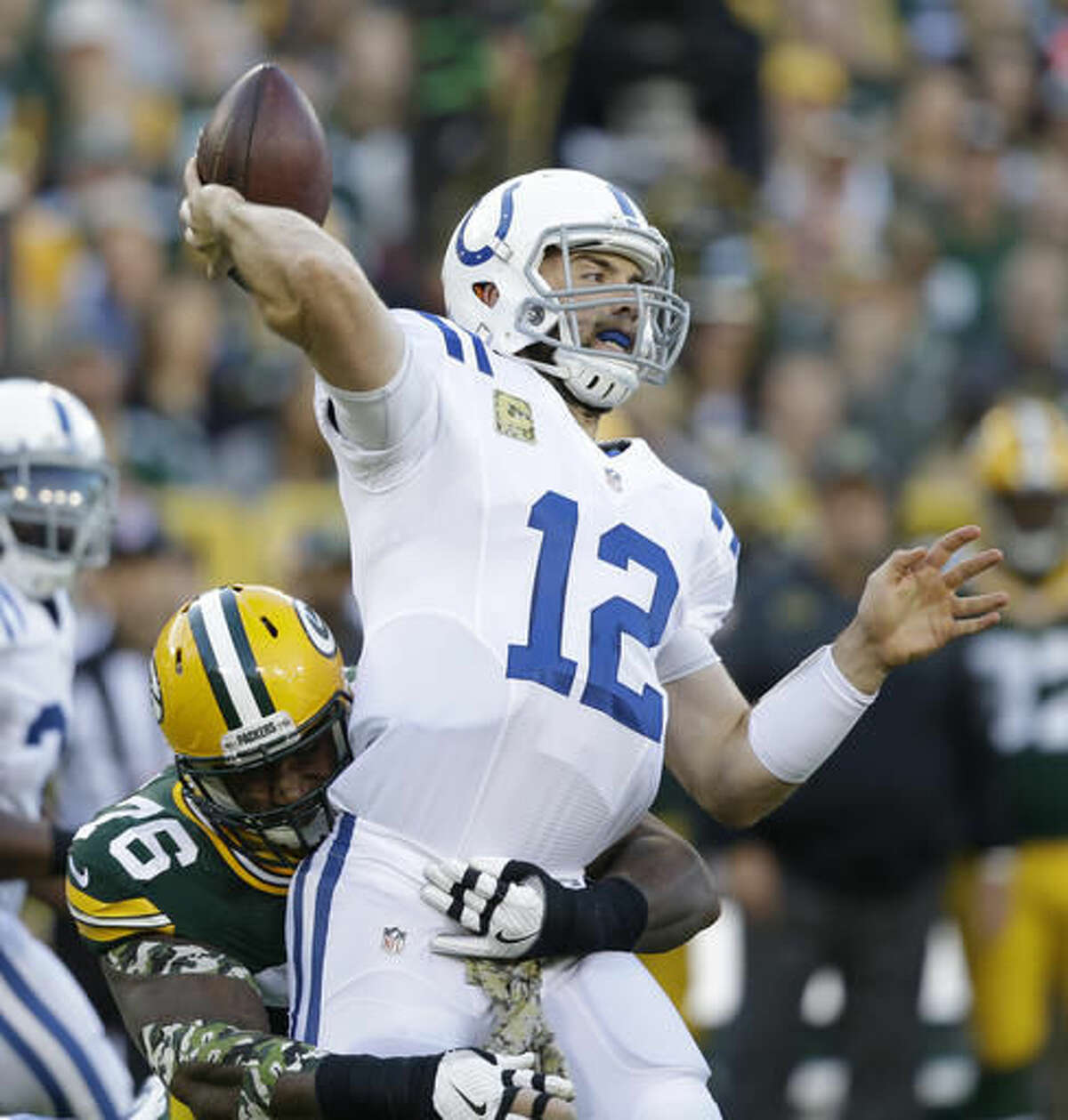 Indianapolis Colts' Andrew Luck is hit by Green Bay Packers' Mike Daniels as he throws during the first half of an NFL football game Sunday, Nov. 6, 2016, in Green Bay, Wis. The pass was intercepted. (AP Photo/Jeffrey Phelps)