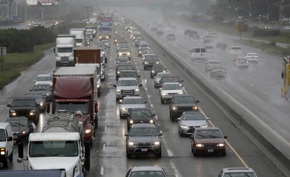 Rain falls as traffic moves north on Interstate 880 in Oakland, Calif., Friday, Oct. 14, 2016. Click through this slideshow to see which cities are the worst for traffic. 