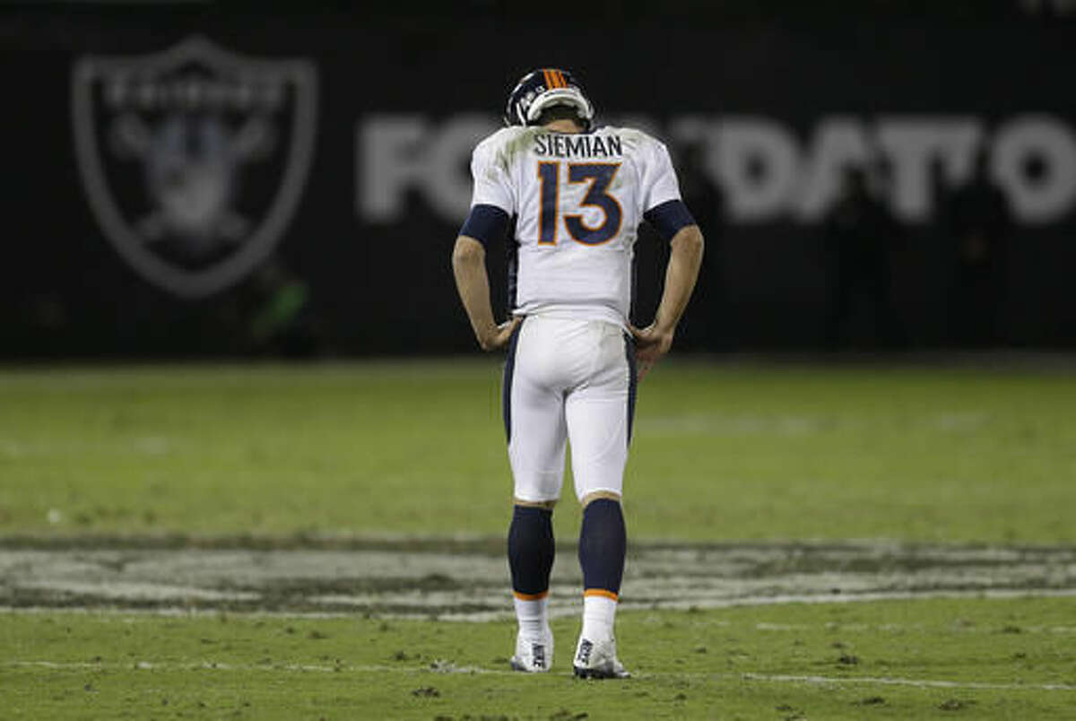 Denver Broncos quarterback Trevor Siemian (13) walks on the field during the second half of an NFL football game against the Oakland Raiders in Oakland, Calif., Sunday, Nov. 6, 2016. (AP Photo/Ben Margot)