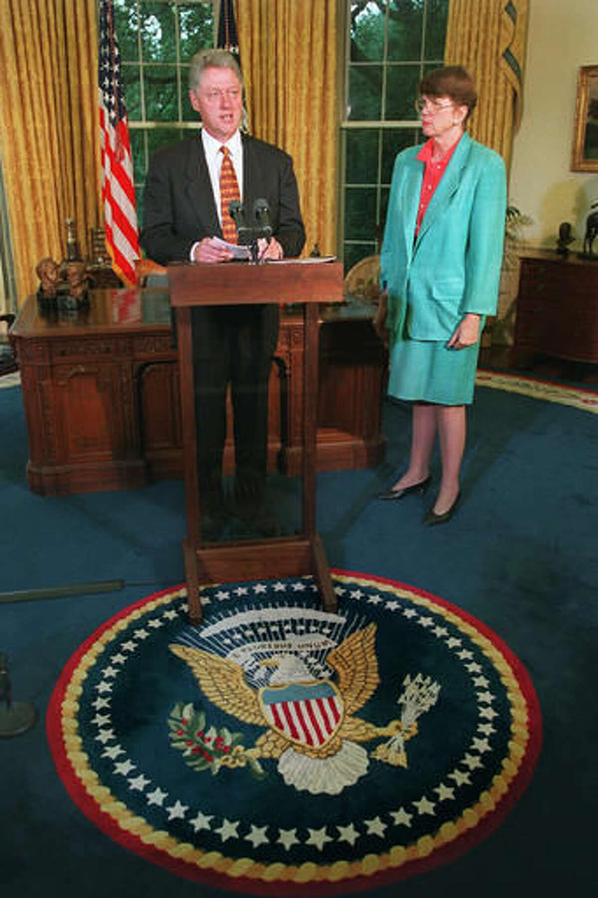 FILE - In this Monday Sept. 16, 1996, file photo, U.S. President Bill Clinton, accompanied by Attorney General Janet Reno, speaks in the Oval Office of the White House after receiving a progress report from the anti-violence initiative. Reno, the first woman to serve as U.S. attorney general and the epicenter of several political storms during the Clinton administration, has died early Monday, Nov. 7, 2016. She was 78. (AP Photo/Ron Edmonds, File)
