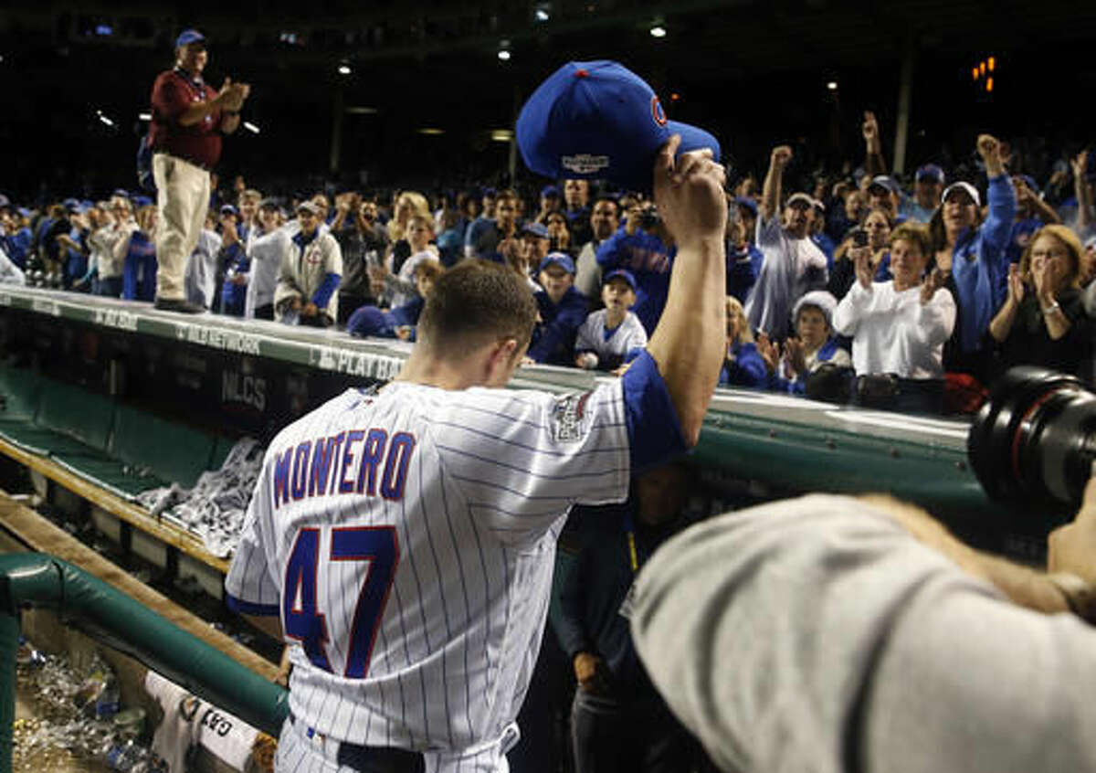 Chicago Cubs' Miguel Montero (47) waves to fans after Game 1 of the National League baseball championship series against the Los Angeles Dodgers Saturday, Oct. 15, 2016, in Chicago. The Cubs won 8-4 to take a 1-0 lead in the series. (AP Photo/Nam Y. Huh)