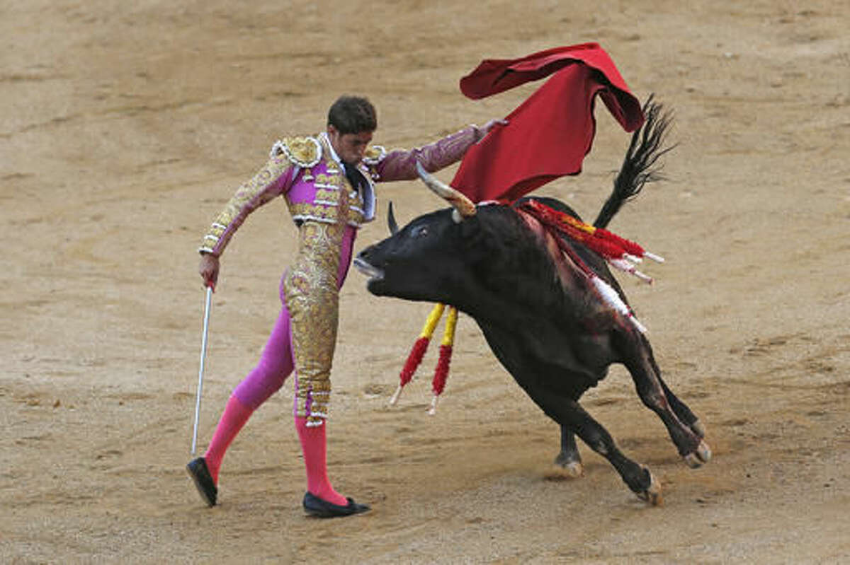 FILE - In a Sunday, Oct. 9, 2016 file photo, Spanish bullfighter Mario Palacios performs with an Aguadulce ranch fighting bull during a bullfight at the Las Ventas bullring in Madrid, Spain. Spain's top court on Thursday, Oct. 20, 2016 overruled a local ban against bullfighting in the powerful northeastern region of Catalonia, saying it violated a national law protecting the spectacle. (AP Photo/Francisco Seco, File)