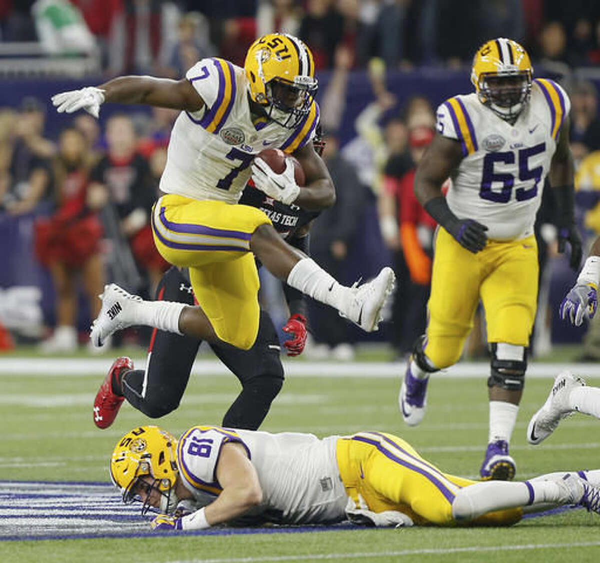 FILE - In this Dec. 29, 2015, file photo, LSU running back Leonard Fournette (7) hurdles tight end Colin Jeter (81) as he rushes against Texas Tech during the first half of the Texas Bowl NCAA college football game in Houston. Lately, the 25th-ranked Tigers have spread out formations and scored on a variety of big plays, and now it appears running back Leonard Fournette could return to the mix for this weekend's clash with No. 23 Mississippi. (AP Photo/Bob Levey, File)