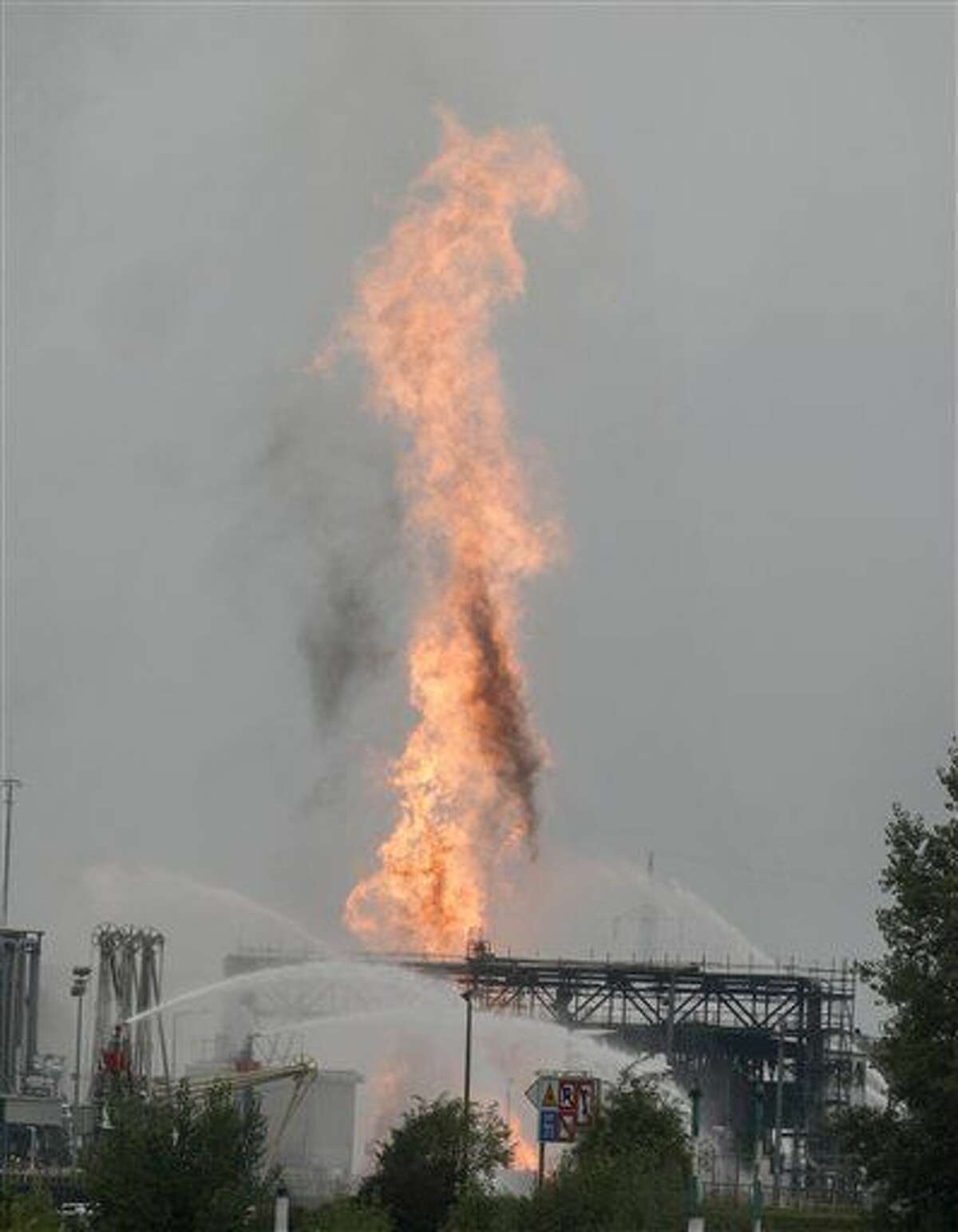 Firefighters extinguish flames during a fire at BASF chemical plant in Ludwigshafen, Germany, Monday Oct. 17, 2016. The company said that several people were injured in a late-morning explosion. (Frank Rumpenhorst/dpa via AP)