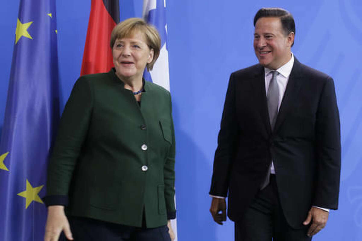German Chancellor Angela Merkel, left, and Panama's President Juan Carlos Varela leave a news conference after talks at the chancellery in Berlin, Tuesday, Oct. 18, 2016. (AP Photo/Markus Schreiber)