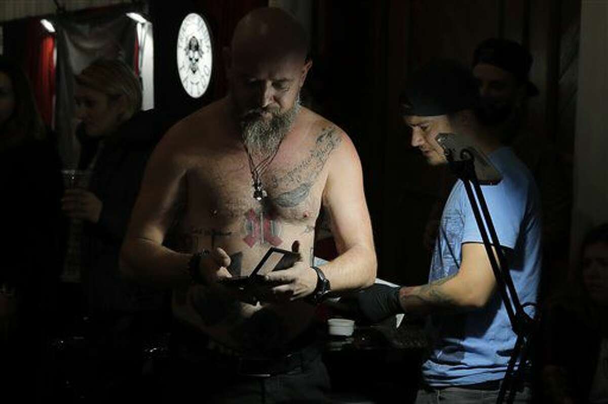 In this picture taken on Sunday, Oct. 16, 2016, a man gets a tattoo during the International Tattoo Convention Bucharest 2016 in Bucharest, Romania. AP Photo/Vadim Ghirda)