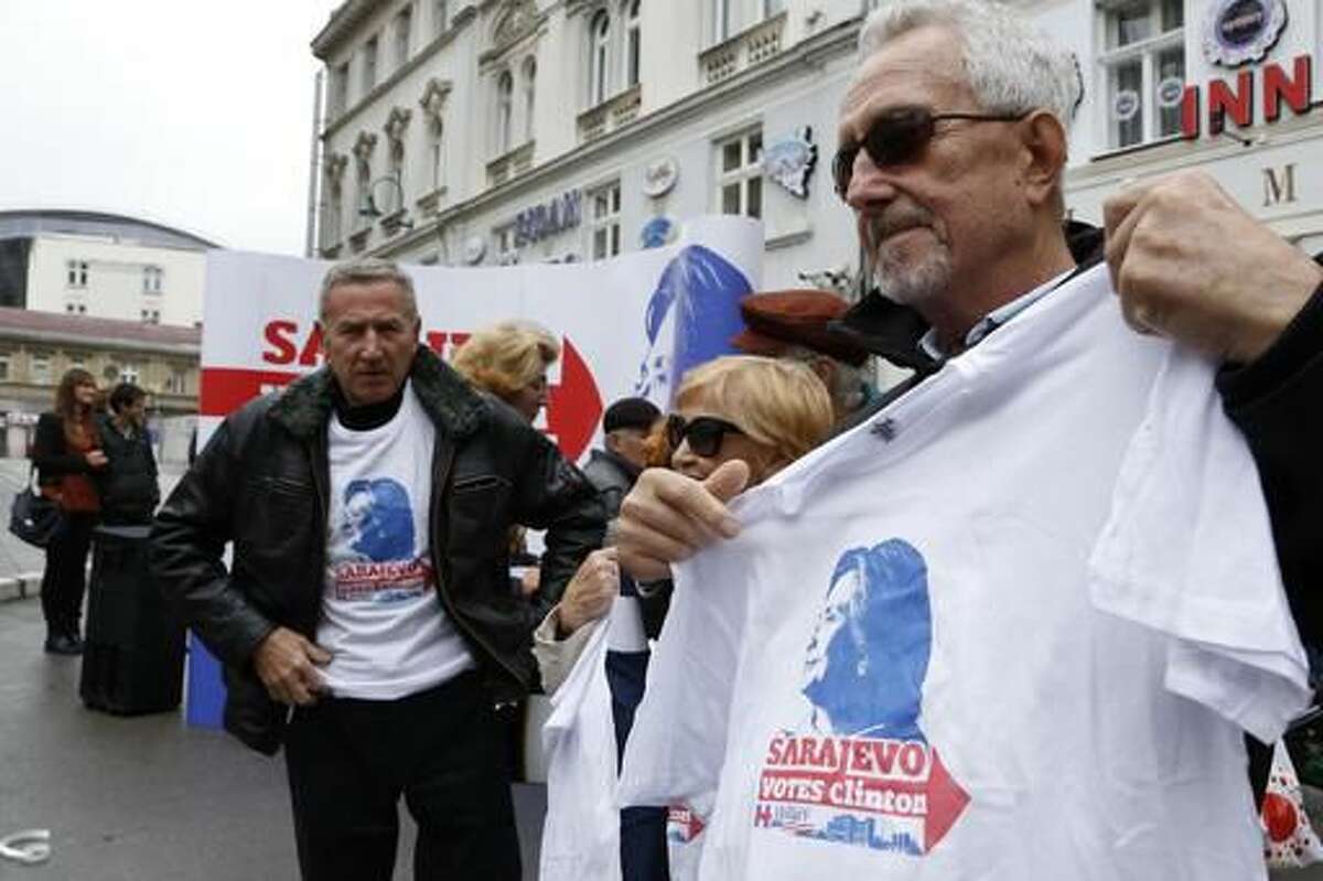 A man shows a t-shirt with the logo of the US presidential candidate Hillary Clinton in Bosnian capital of Sarajevo on Saturday, Oct. 22, 2016. Hundreds of Sarajevo residents gathered Saturday at the square to sign a petition of support for US presidential candidate Hillary Clinton as they are thankful for the involvement of both Bill Clinton as a president and Hillary as a secretary of state for their work and efforts in stopping of brutal Bosnian war in the 1990's and later formation of modern and democratic Bosnia Hercegovina. (AP Photo/Amel Emric)