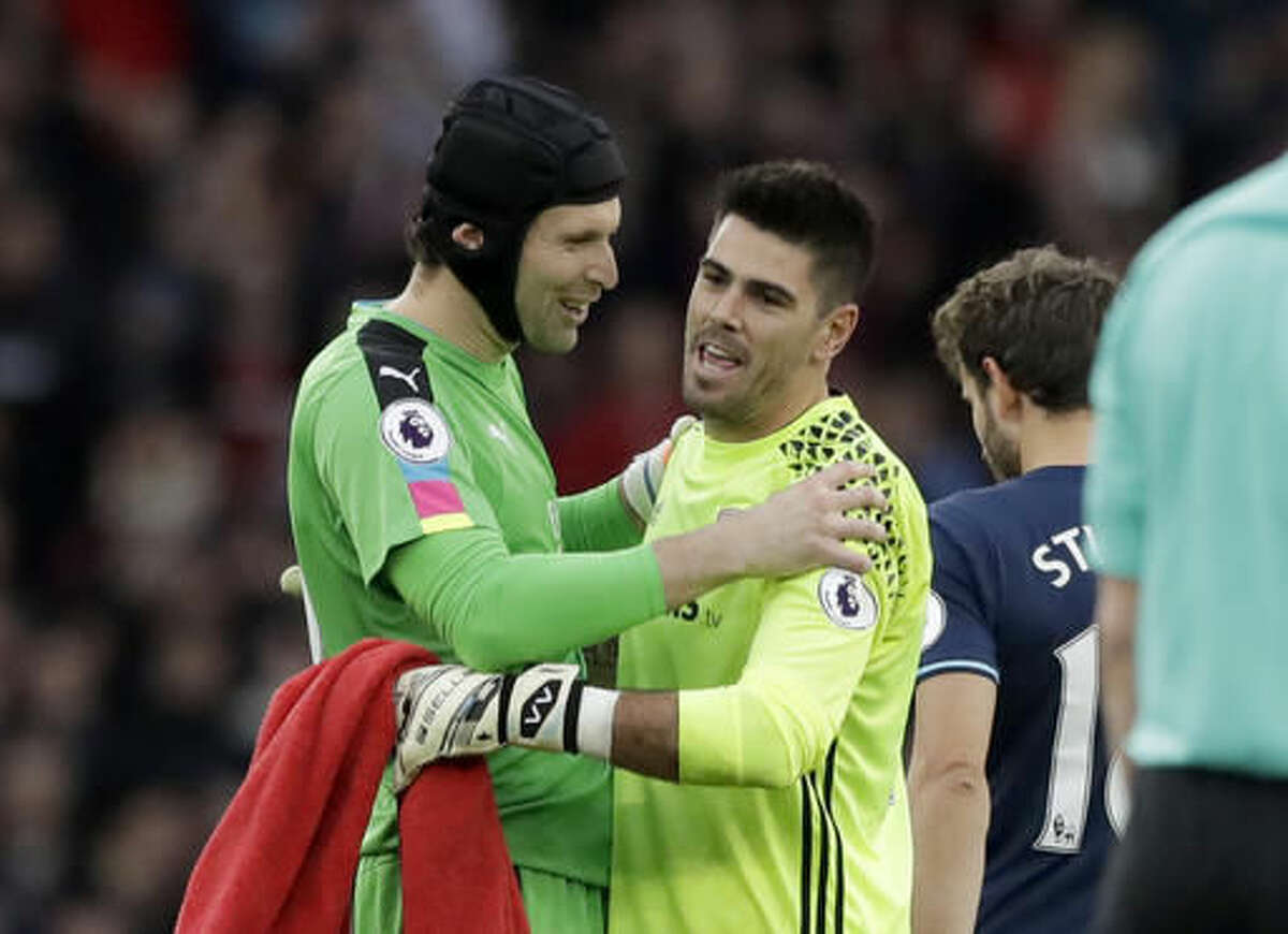 Arsenal's goalkeeper Petr Cech, left, embraces Middlesbrough's goalkeeper Victor Valdes after the final whistle of the English Premier League soccer match between Arsenal and Middlesbrough at the Emirates Stadium in London, Saturday, Oct. 22, 2016. (AP Photo/Matt Dunham)