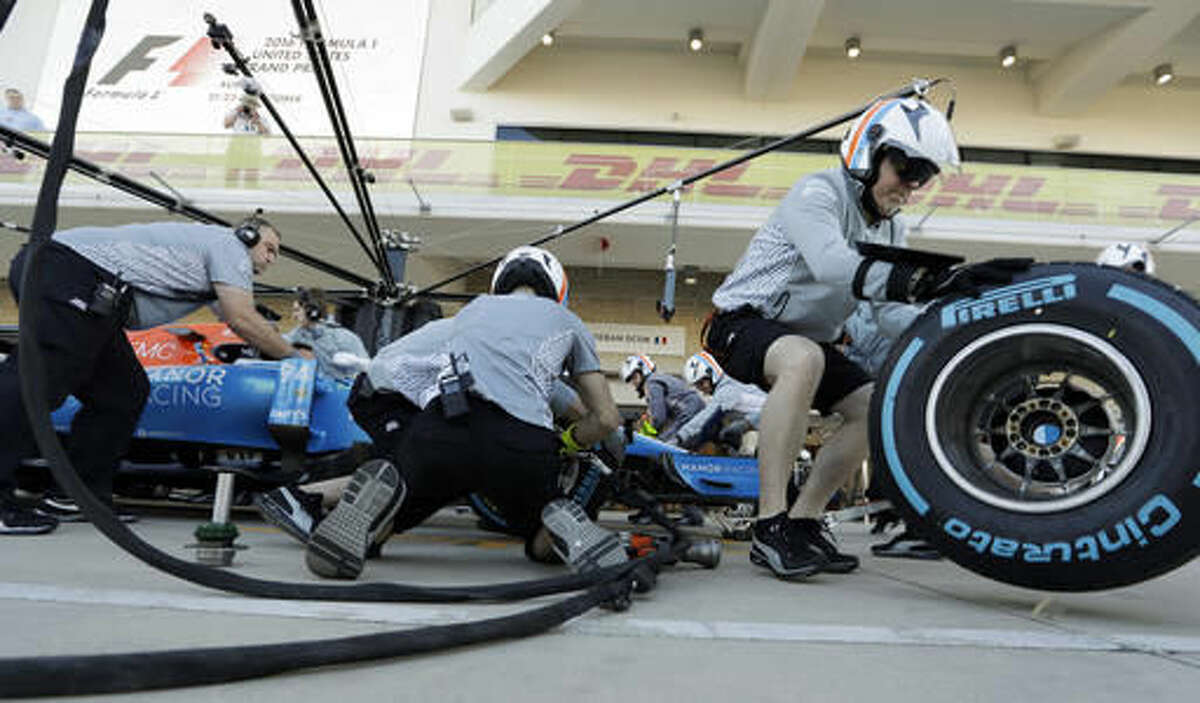 The crew for Manor driver Pascal Wehrlein, of Germany, practice pit stops for the Formula One U.S. Grand Prix auto race at the Circuit of the Americas, Saturday, Oct. 22, 2016, in Austin, Texas. (AP Photo/Eric Gay)