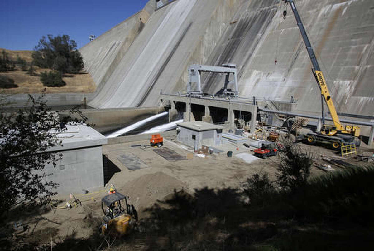 In a Wednesday, Oct. 5, 2016, photo, the Friant dam is shown where the San Joaquin River restoration project begins in Friant, Calif. A decade ago, environmentalists and the federal government agreed to revive a 150-mile stretch of California's second-longest river, an ambitious effort aimed at allowing salmon to again swim up to the Sierra Nevada foothills to spawn. (AP Photo/Gary Kazanjian)