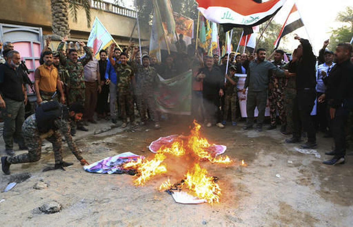 Iraqi protesters burn Turkish flags and Israeli flags during a demonstration calling for the withdrawal of Turkish troops from northern Iraq, in Basra, 340 miles (550 kilometers) southeast of Baghdad, Iraq on Saturday, Oct. 22, 2016.(AP Photo/Nabil al-Jurani)