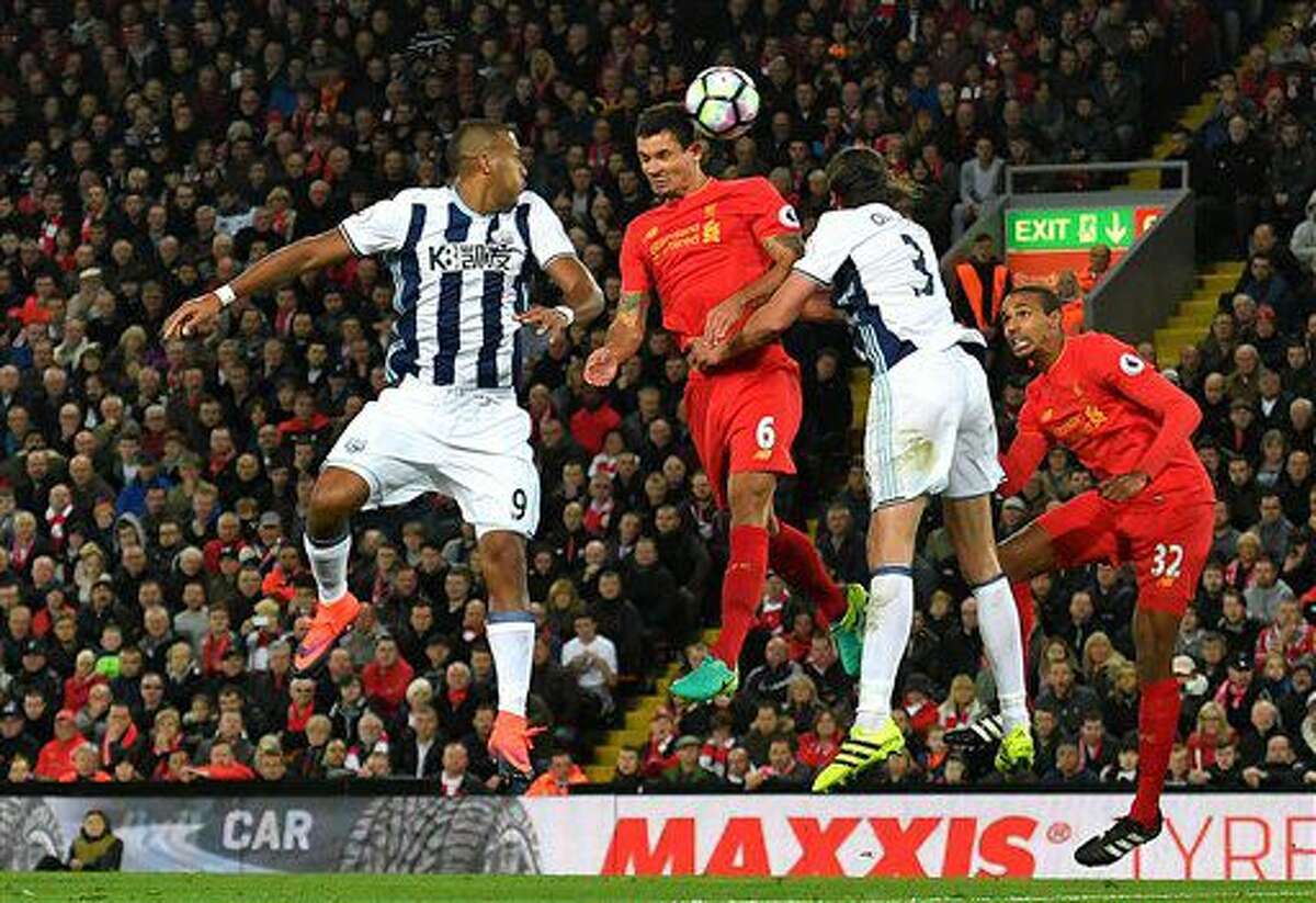 Liverpool's Dejan Lovren, centre, battles for the ball with West Bromwich Albion's Jose Salomon Rondon, left, and West Bromwich Albion's Jonas Olsson, second right, during the English Premier League soccer match between Liverpool and West Bromwich Albion at Anfield stadium, Liverpool, England, Saturday, Oct. 22, 2016. (Dave Howarth/PA via AP)