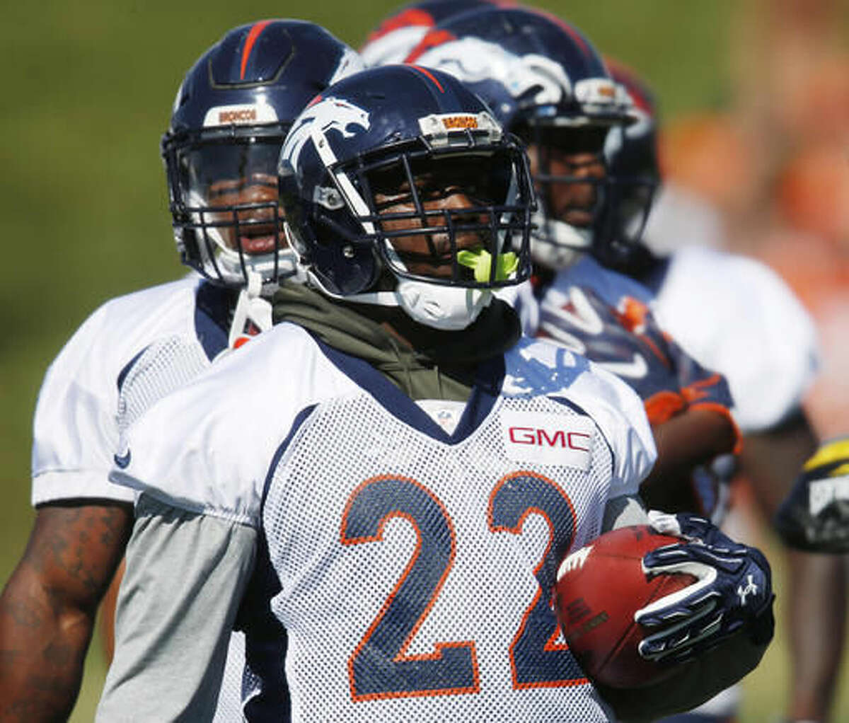 FILe - In this Monday, Aug. 8, 2016, file photo, Denver Broncos running back C.J. Anderson takes part in drills during the team's NFL football practice in Englewood, Colo. Anderson, who has been a mainstay in the team's backfield the past couple seasons, is fighting for playing time with rookie Devontae Booker, which has created a quandary for the Broncos' coaches. (AP Photo/David Zalubowski, file)