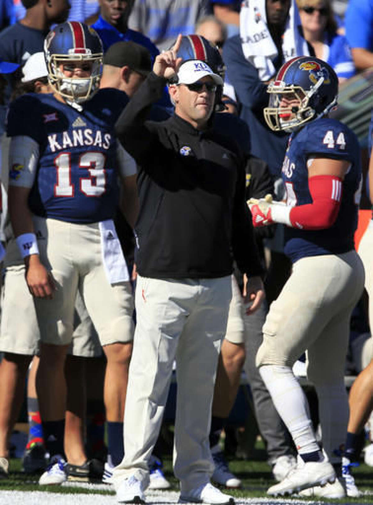 Kansas head coach David Beaty signals a play during the first half of an NCAA college football game against Oklahoma State in Lawrence, Kan., Saturday, Oct. 22, 2016. (AP Photo/Orlin Wagner)