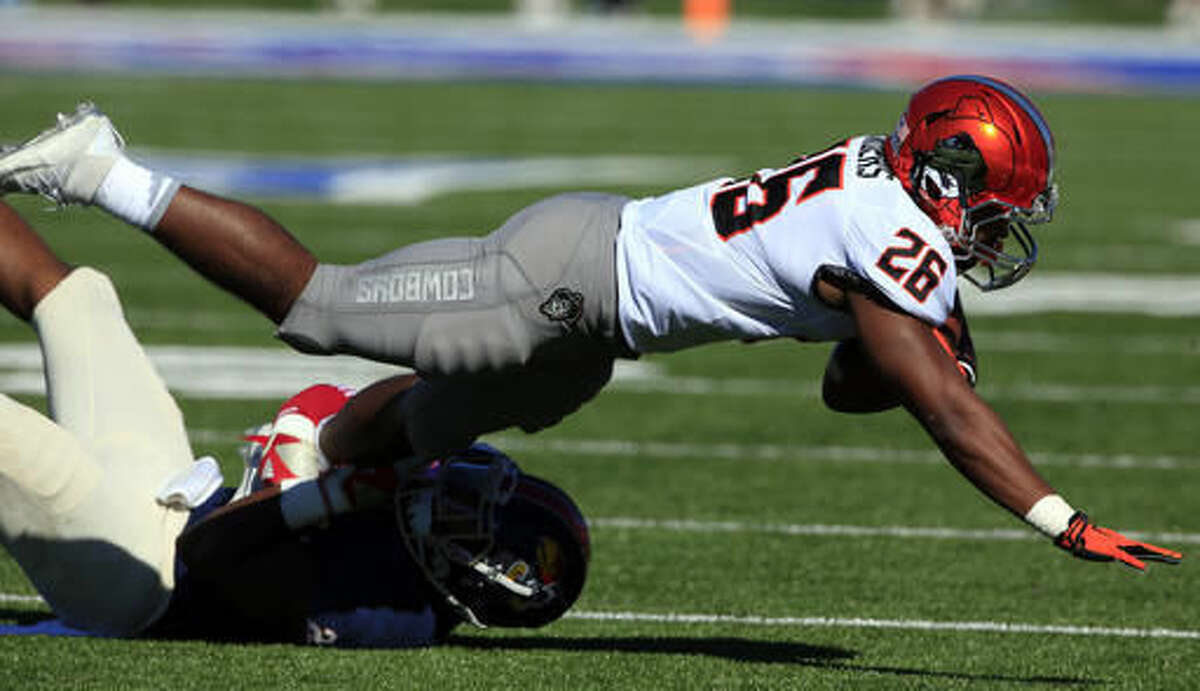 Oklahoma State running back Barry Sanders (26) is tackled by Kansas linebacker Courtney Arnick (28) during the first half of an NCAA college football game in Lawrence, Kan., Saturday, Oct. 22, 2016. (AP Photo/Orlin Wagner)