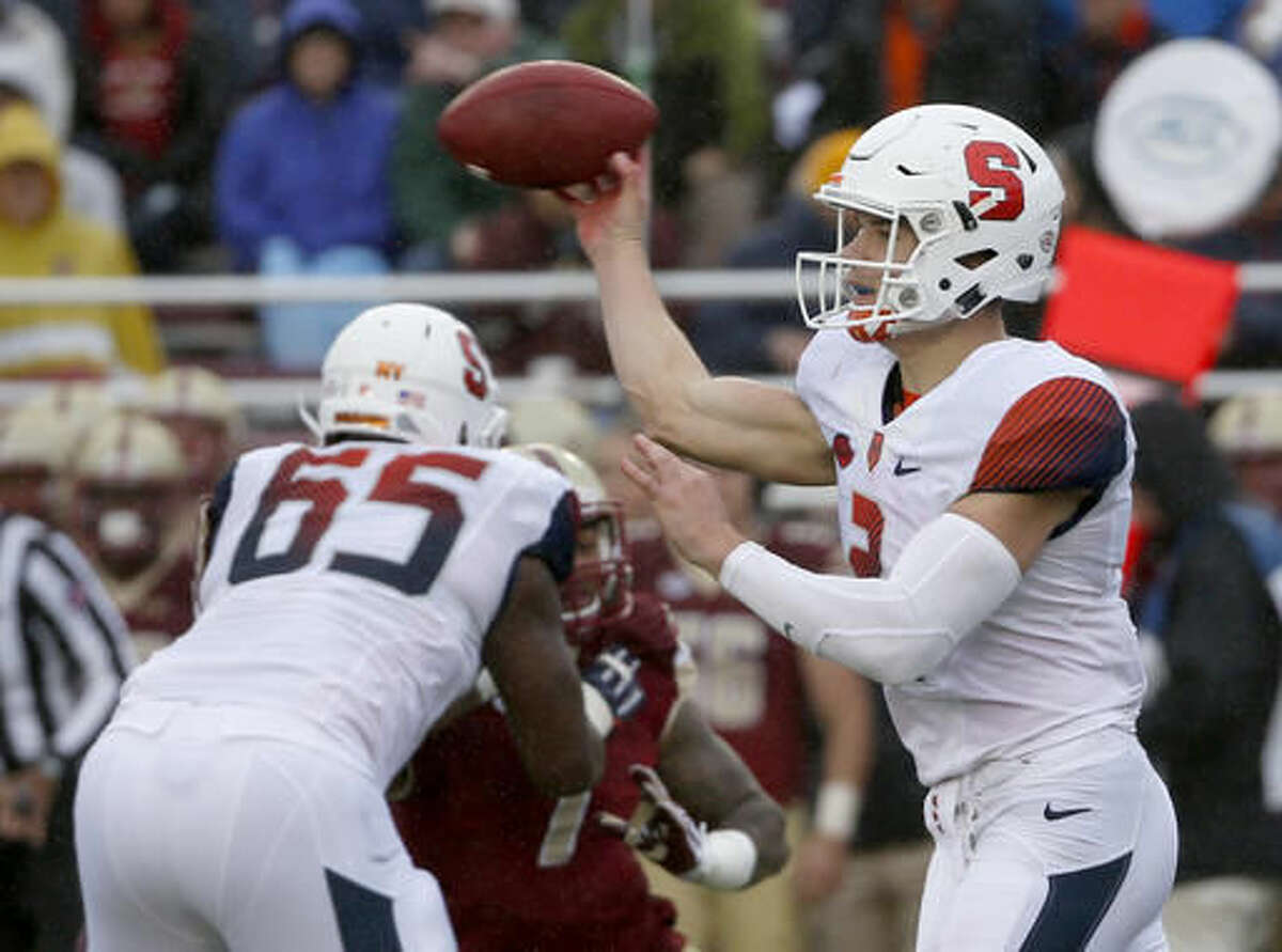 Syracuse quarterback Eric Dungey (2) passes as he gets a block from offensive lineman Jamar McGloster (65) during the first half of an NCAA college football game against Boston College, Saturday, Oct. 22, 2016, in Boston. (AP Photo/Mary Schwalm)