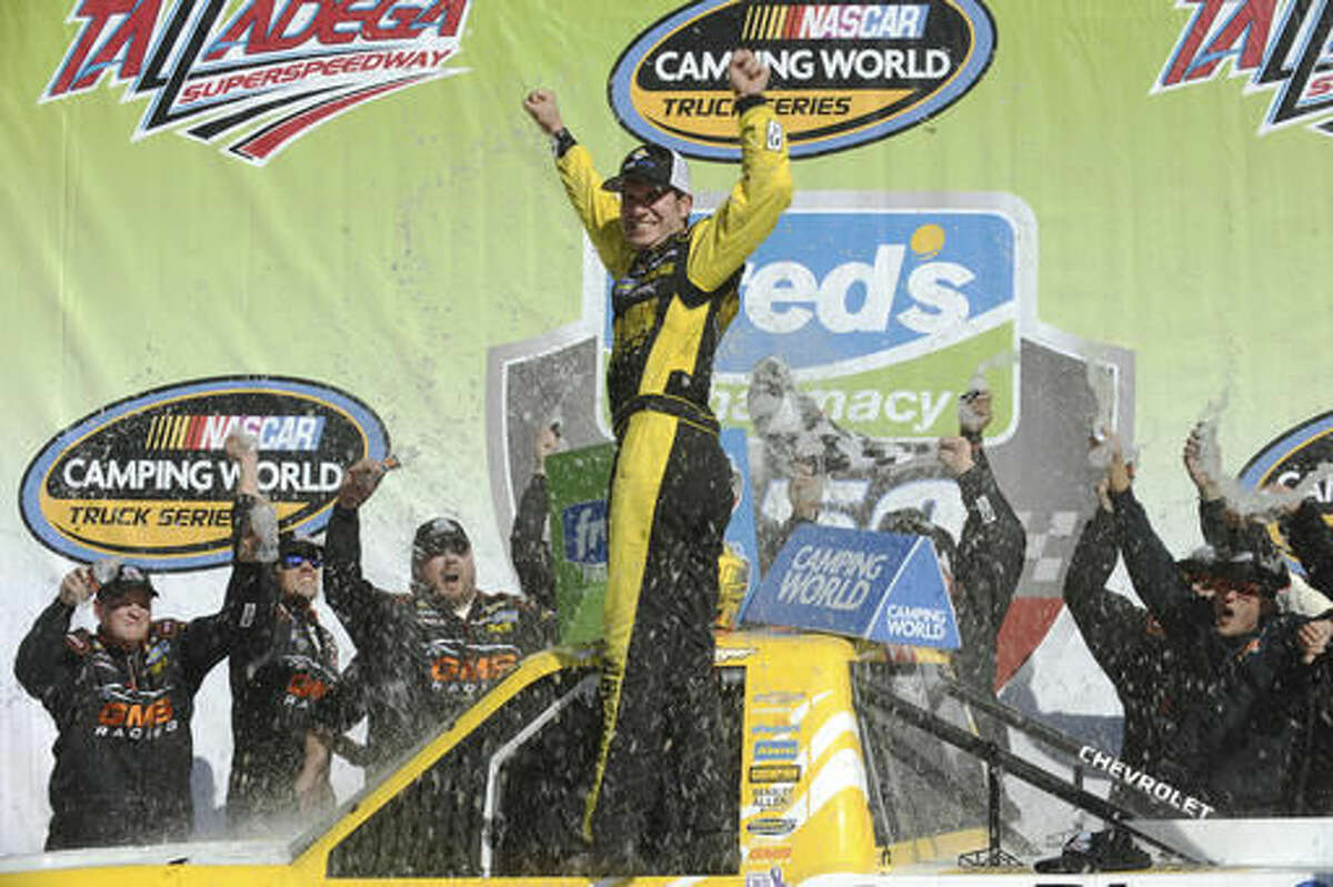 Grant Enfinger celebrates in Victory Lane after winning the NASCAR Camping World Truck Series race at Talladega Superspeedway on Saturday, Oct. 22, 2016, in Talladega, Ala. (AP Photo/Rainier Ehrhardt)