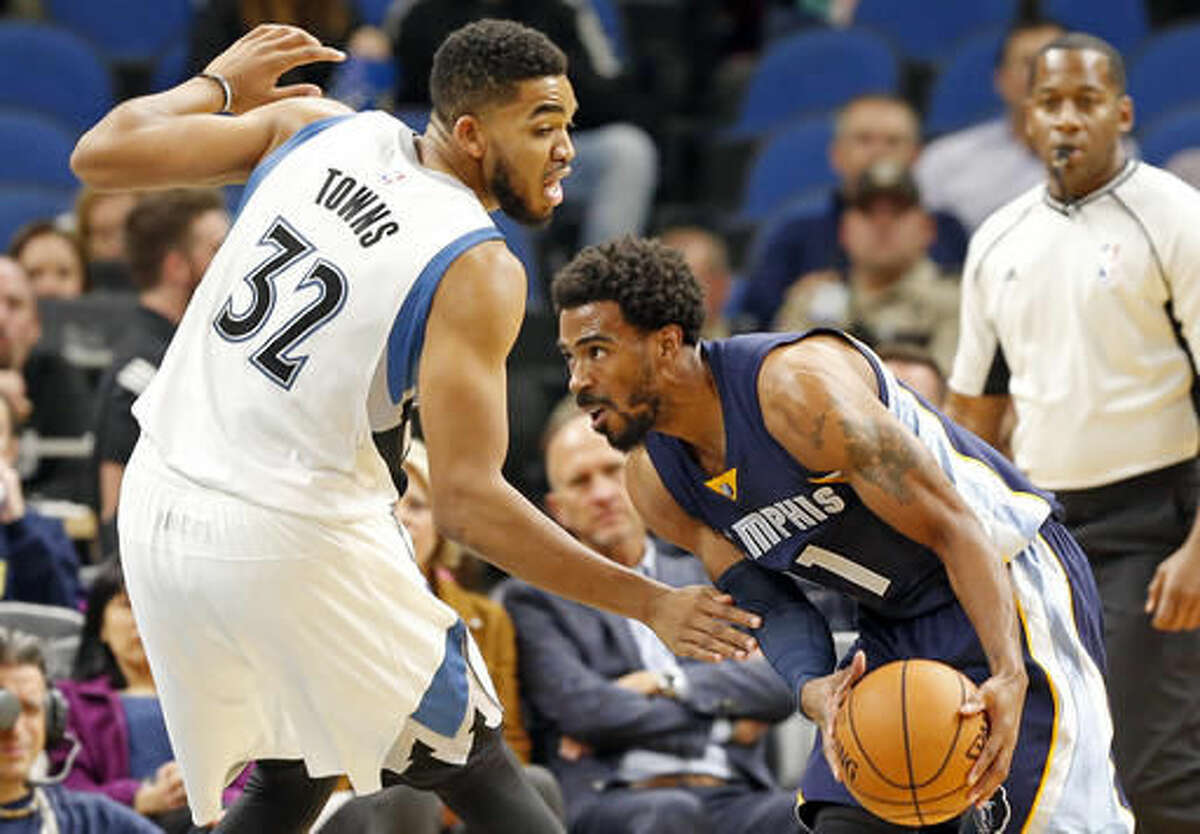 Memphis Grizzlies' Mike Conley, right, drives past Minnesota Timberwolves' Karl-Anthony Towns during the first quarter of an NBA preseason basketball game Wednesday, Oct. 19, 2016, in Minneapolis. (AP Photo/Jim Mone)