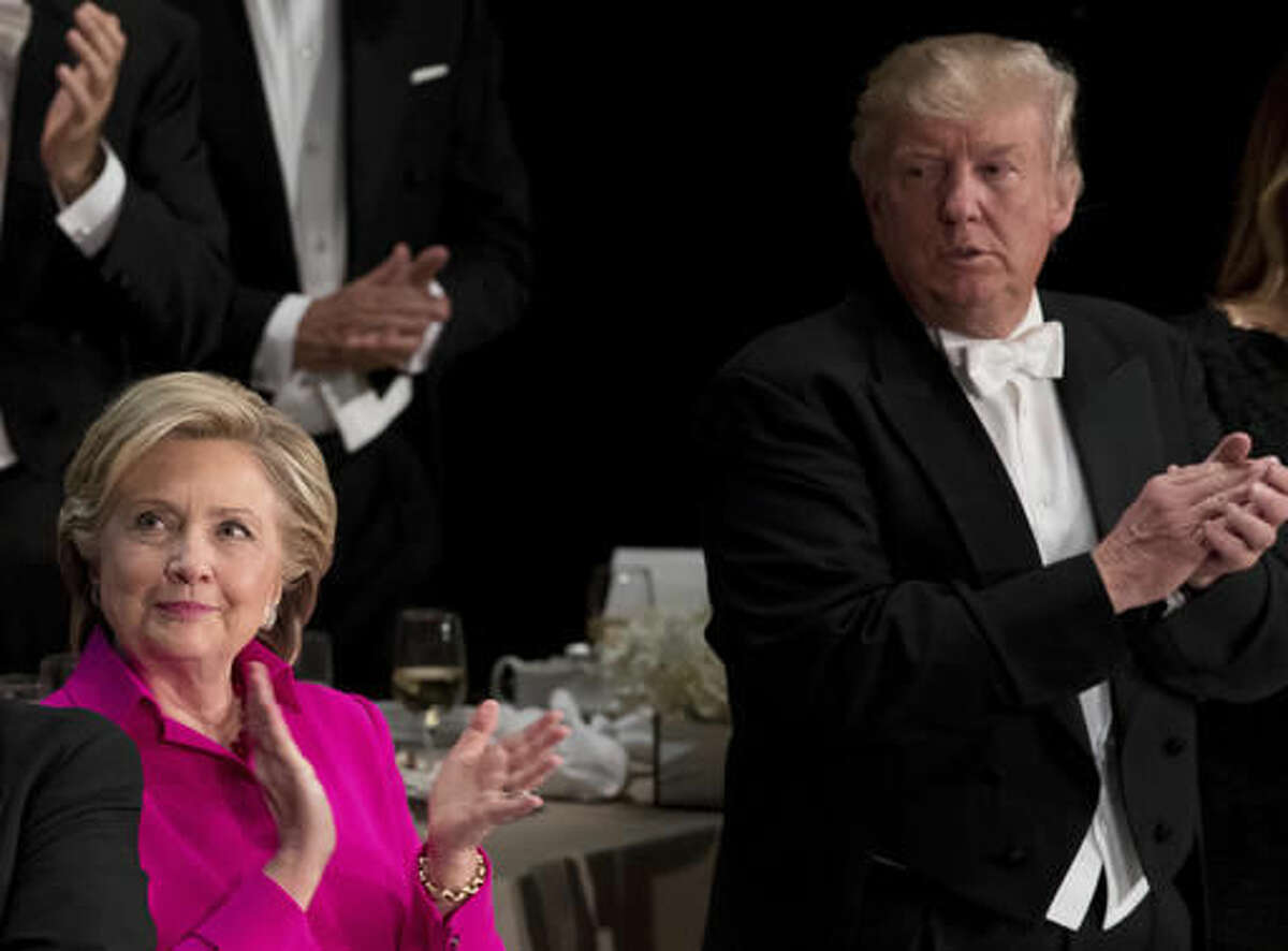 Democratic presidential candidate Hillary Clinton, left, and Republican presidential candidate Donald Trump, right, stand next to each other towards the end of the 71st annual Alfred E. Smith Memorial Foundation Dinner, a charity gala organized by the Archdiocese of New York, Thursday, Oct. 20, 2016, at the Waldorf Astoria hotel in New York. (AP Photo/Andrew Harnik)