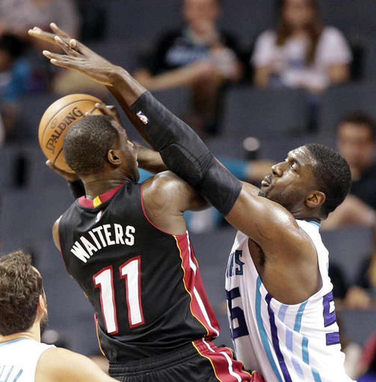 Charlotte Hornets' Roy Hibbert (55) blocks a shot by Miami Heat's Dion Waiters (11) in the first half of a preseason NBA basketball game in Charlotte, N.C., Thursday, Oct. 20, 2016. (AP Photo/Chuck Burton)