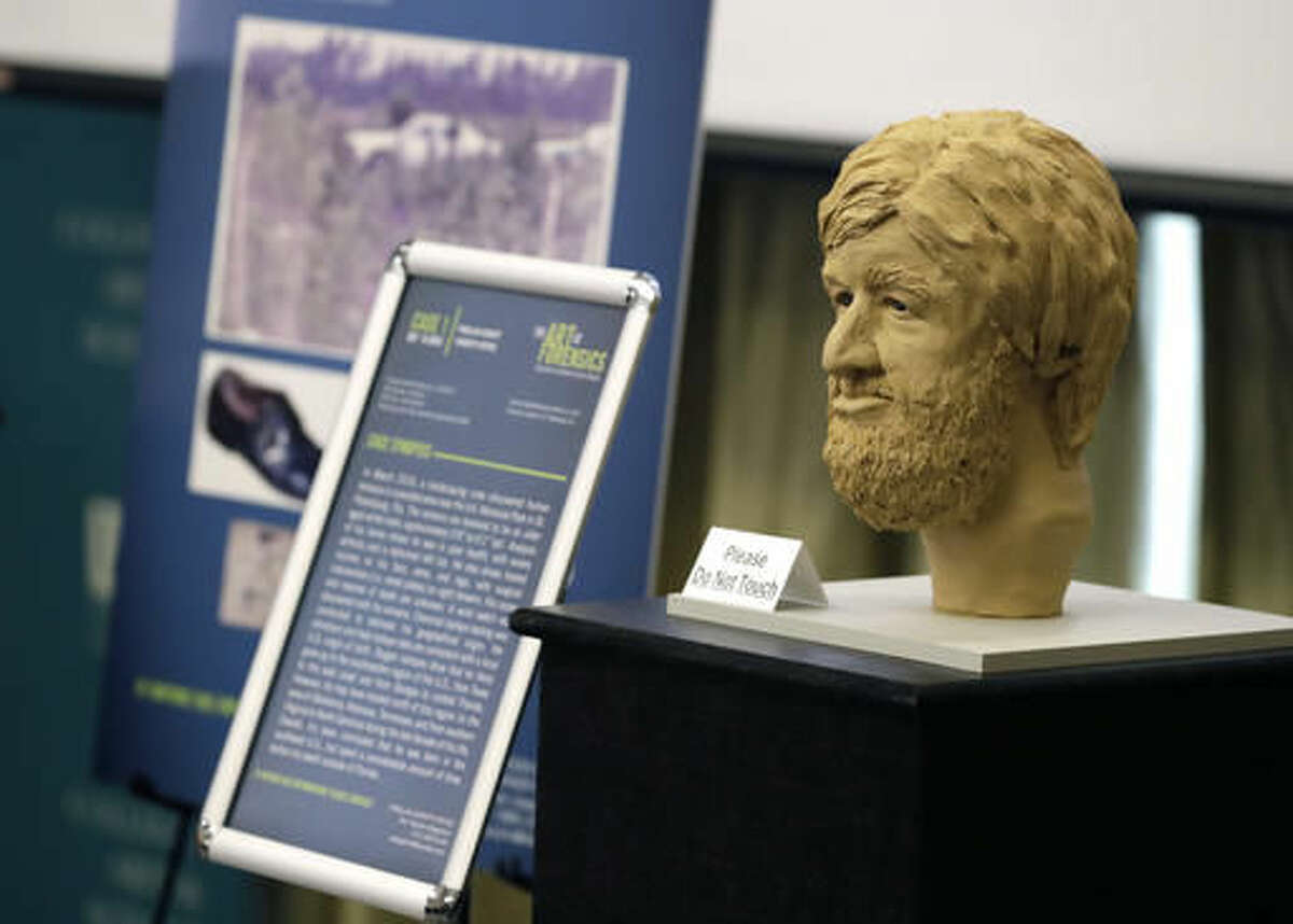A clay bust and details surrounding an unidentified victim in a Florida cold case file is shown during the the Art of Forensics conference Friday, Oct. 21, 2016, in Tampa, Fla. University of South Florida associate professor for Anthropology Erin Kimmerle, and several forensic artists, have been working with law enforcement on cold cases in order to help victims have a face in hopes family members may recognize them. (AP Photo/Chris O'Meara)