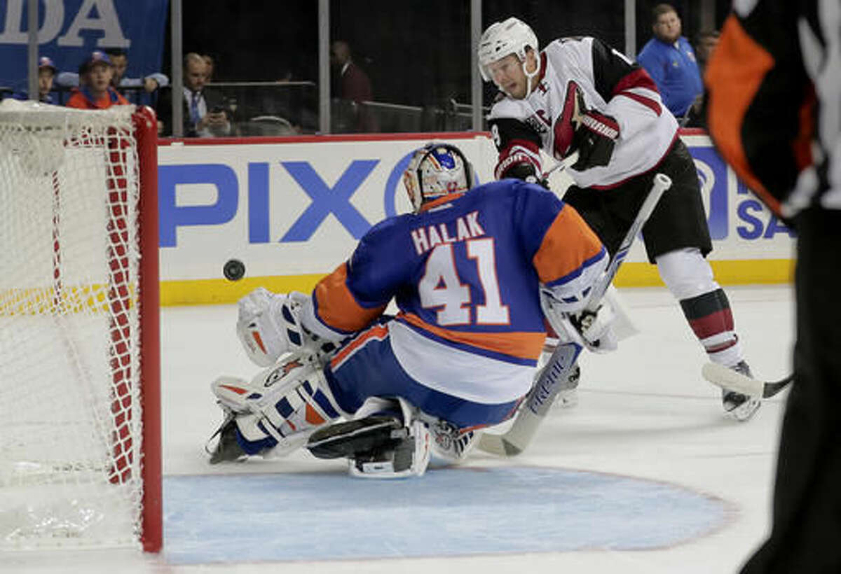 New York Islanders goalie Jaroslav Halak (41) blocks a shot by Arizona Coyotes right wing Shane Doan (19) during the first period of an NHL hockey game, Friday, Oct. 21, 2016, in New York. (AP Photo/Julie Jacobson)
