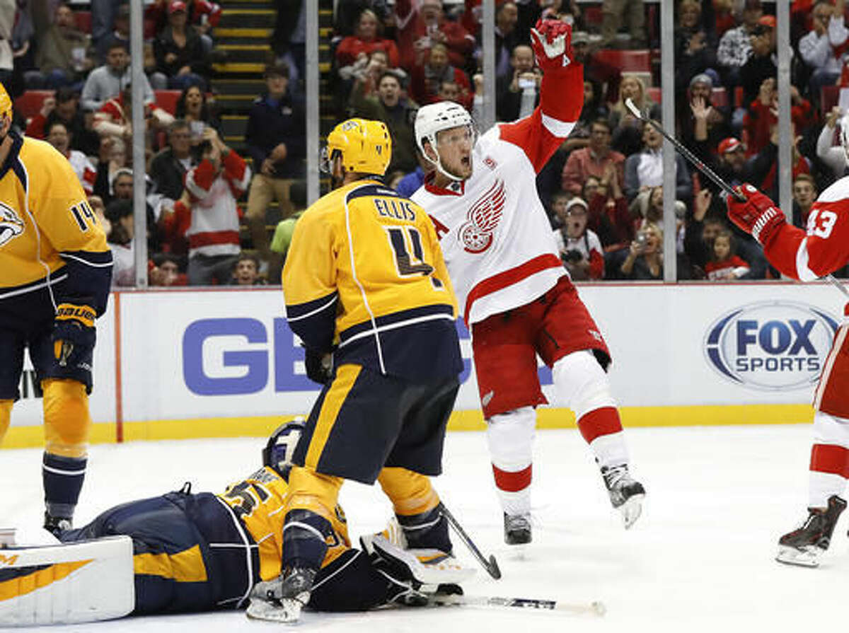 Detroit Red Wings left wing Justin Abdelkader (8) celebrates his goal against Nashville Predators goalie Pekka Rinne (35) during the second period of an NHL hockey game Friday, Oct. 21, 2016, in Detroit. (AP Photo/Paul Sancya)