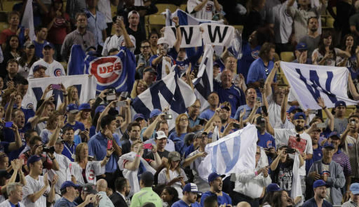 Chicago Cubs fans celebrate in Dodger Stadium after Game 5 of the National League baseball championship series against the Los Angeles Dodgers Thursday, Oct. 20, 2016, in Los Angeles. The Cubs won 8-4 to take a 3-2 lead in the series. (AP Photo/Jae C. Hong)