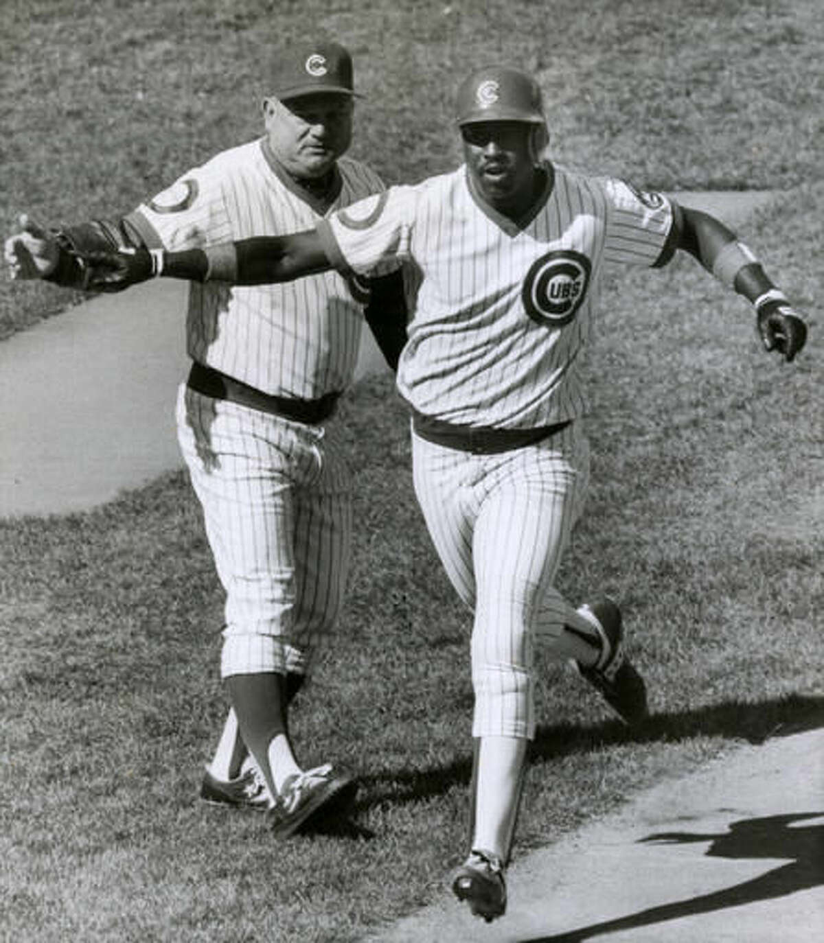 FILE - In this Oct. 2, 1984, file photo, Chicago Cubs third base coach Don Zimmer, left, congratulates Gary Matthews on his home run of San Diego Padres' Eric Snow during the first inning of Game 1 of the NL Championship Series in Chicago. Matthews hit another homer later in the game. Matthews was a Cubs star when the team lost three straight games in the NLCS in 1984 and missed going the World Series. In 2003, he was the Cubs' hitting coach when they again lost three in a row in the NLCS and missed a chance to reach the World Series. (AP Photo/Fred Jewell, File)