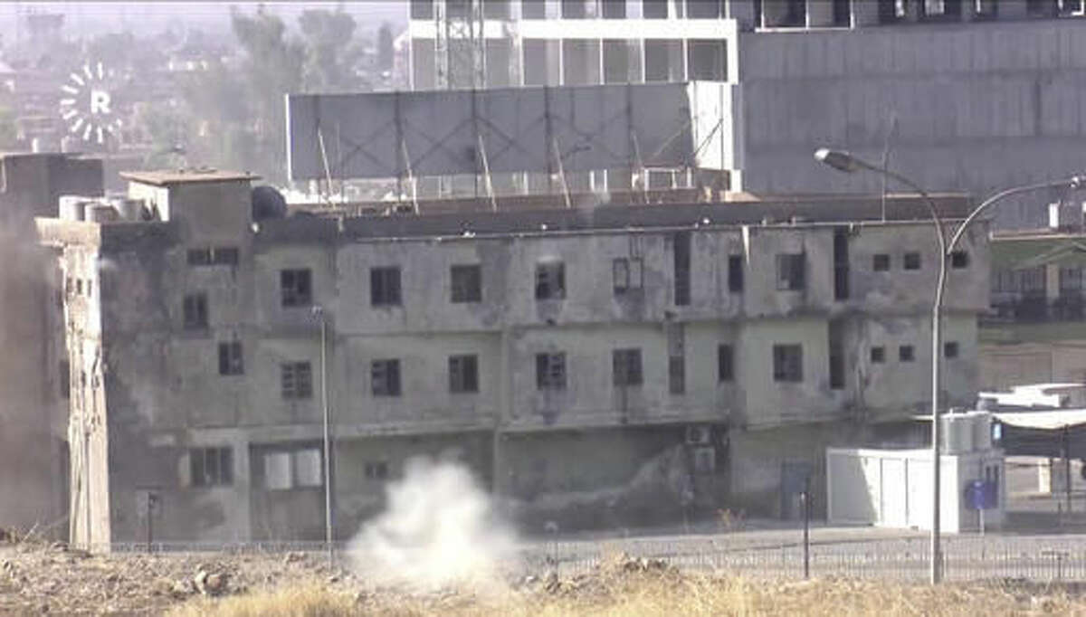 In this image made from video, smoke rises from a building where two militants are believed to be holed up, according to Rudaw TV, in Kirkuk, Iraq, Friday, Oct. 21, 2016. Militants armed with assault rifles and explosives attacked targets in and around the northern Iraqi city of Kirkuk early on Friday in an assault quickly claimed by the Islamic State group and likely aimed at diverting authorities' attention for the battle to retake IS-held Mosul. (Rudaw TV via AP)
