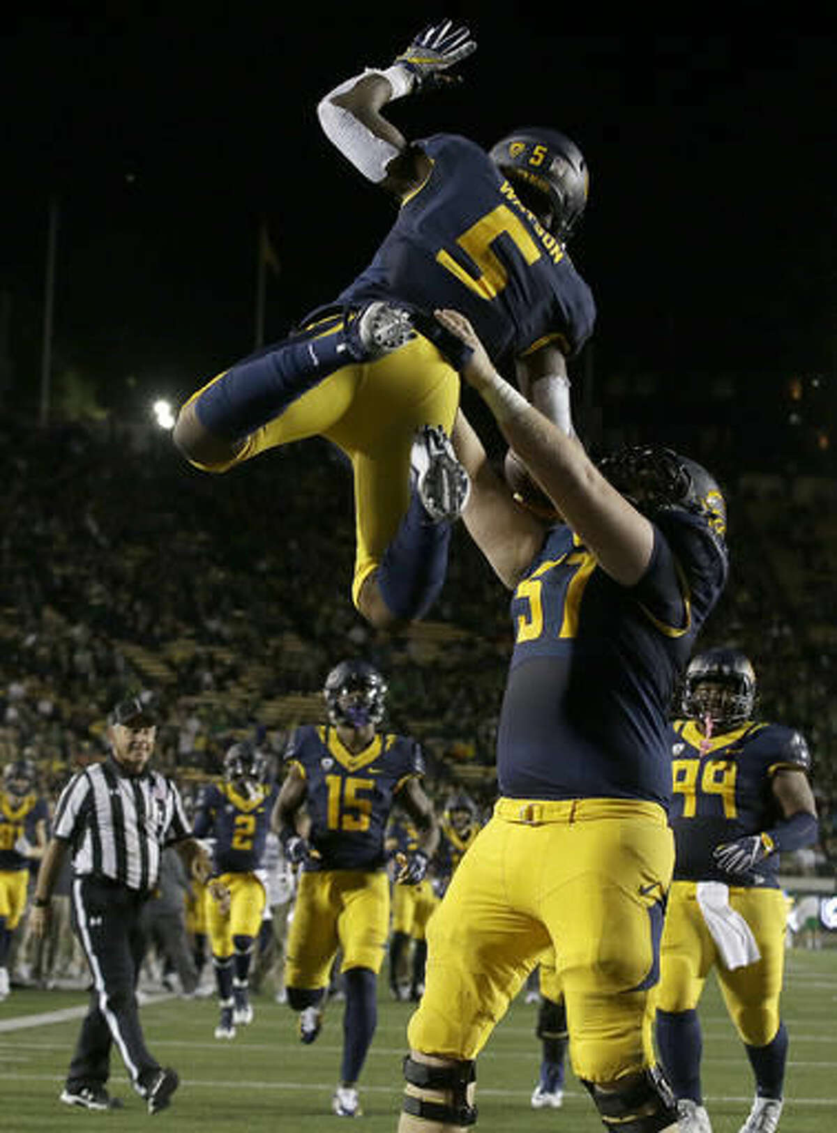 California running back Tre Watson (5) celebrates after catching a touchdown pass, with offensive lineman Addison Ooms (57) during the first half of an NCAA college football game against Oregon in Berkeley, Calif., Friday, Oct. 21, 2016. (AP Photo/Jeff Chiu)