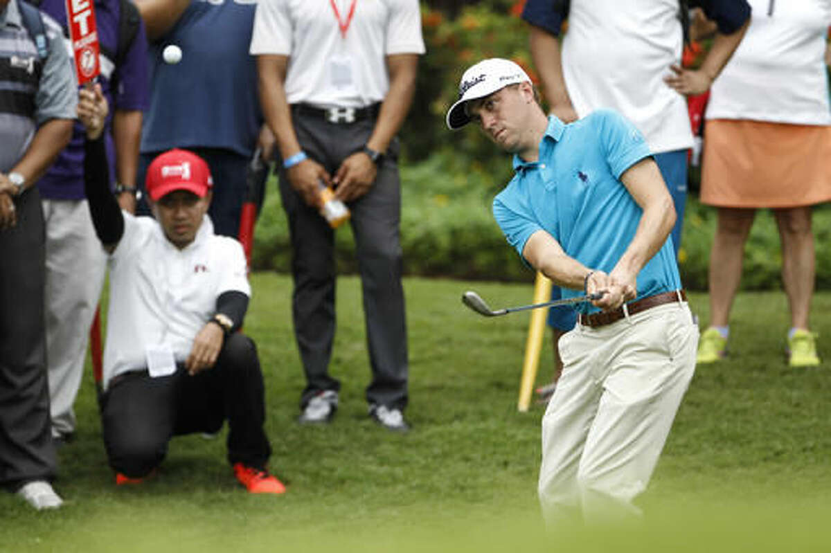 Justin Thomas of the United States watches his shot on the fifth green during the third round of the CIMB Classic golf tournament at Tournament Players Club in Kuala Lumpur, Malaysia, Saturday, Oct. 22, 2016. (AP Photo/Joshua Paul)